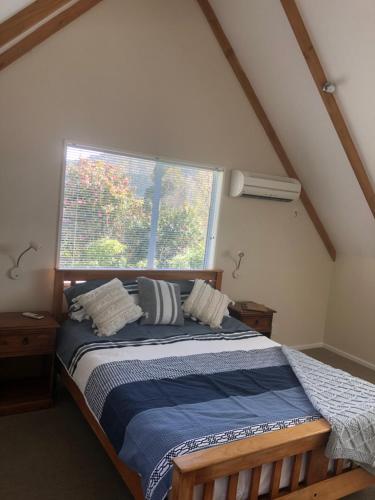 a bedroom with a bed in front of a window at Rochdale Homestay B&B in Havelock