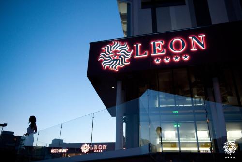 a neon sign on the side of a building at Hotel Leon & Spa in Arad