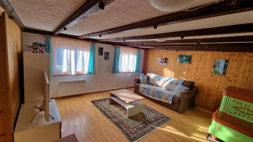 a living room with a couch and a table at Chez Rosalie in La Roche