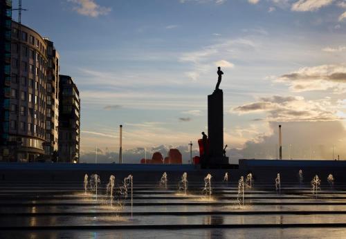 a statue of a person on a pedestal in a city at Hotel Ter Streep in Ostend
