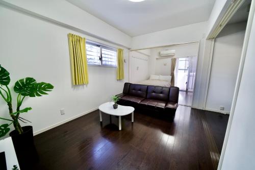 a living room with a couch and a table at Villa Izumizaki in Naha