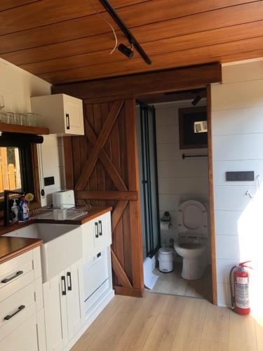 a kitchen with a bathroom with a toilet in it at Tiny house kayaköy Nar in Fethiye