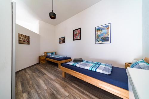 a living room with two beds and a couch at Apartment 4 an der Messe Friedrichshafen in Friedrichshafen