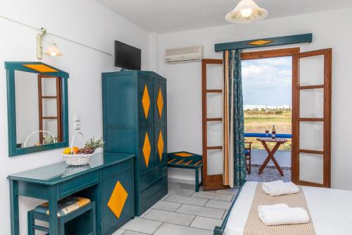 a room with a blue dresser and a mirror at Surfer Paradise in Naxos Chora