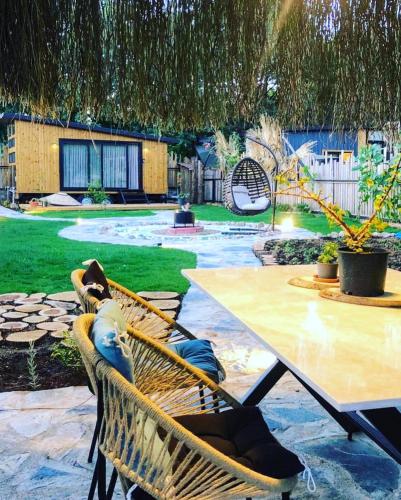 a patio with a table and a hammock and a table at Tiny house kayaköy Nar in Fethiye