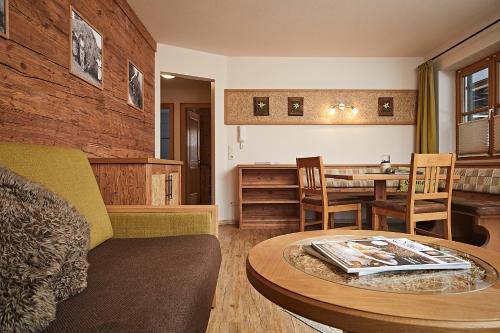 a living room with a couch and a table at Siplinger Suites - Ferienwohnungen - Sauna und Fitness in Balderschwang