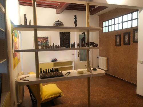 a room with a desk and shelves with vases at Palazzo Cordoni in Città di Castello