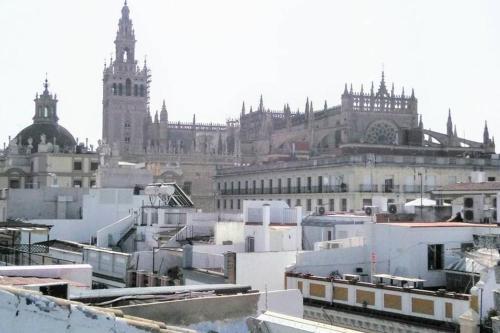 vistas a una ciudad con un gran edificio en Top-notch downtown house with private rooftop terrace and parking opt en Sevilla