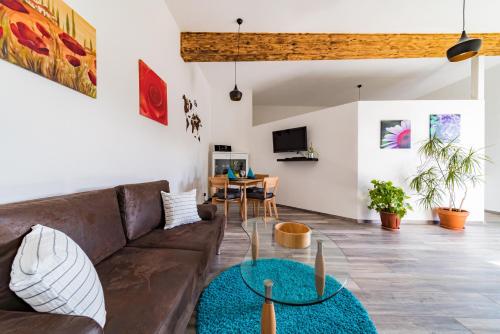 a living room with a couch and a table at Apartment 4 an der Messe Friedrichshafen in Friedrichshafen