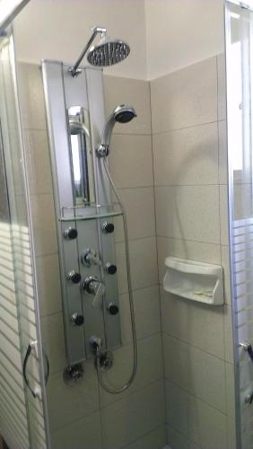 a shower in a bathroom with a glass door at Villa Konaki in Grammatiko