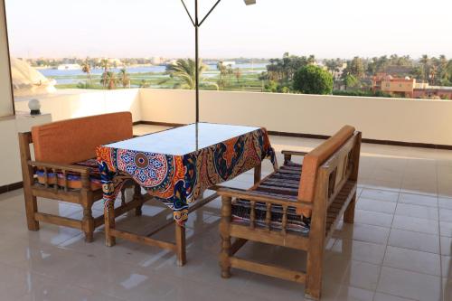 a table and two chairs with a view of the desert at DREAM ISLAND Hotel in Luxor