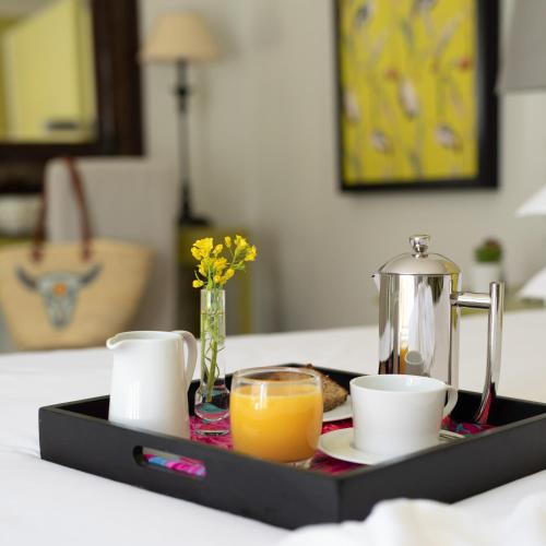 a tray with an orange juice and coffee on a table at The Parkwood in Johannesburg