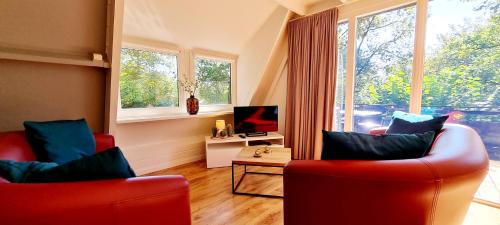 Télévision ou salle de divertissement dans l'établissement Les Jardins de Durbuy