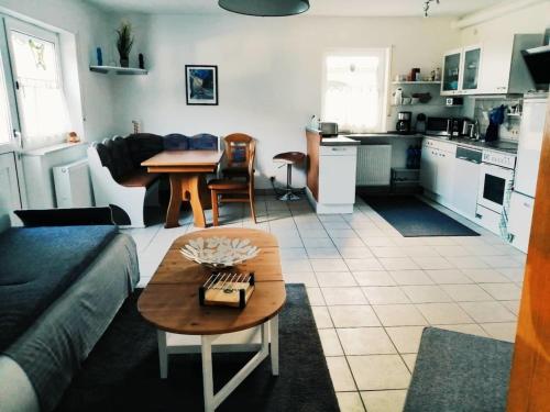 a living room with a couch and a table at 76 qm Whg im EG Haus-Wohlfühloase vor der Haustür in Gladenbach