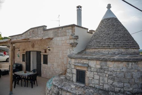 an outside view of a stone building with a roof at Trullo Monticello in Martina Franca