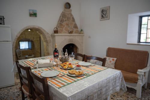 a table with food and wine on it in a kitchen at Trullo Monticello in Martina Franca