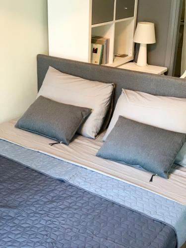 a bed with two pillows on top of it at Confidential apartment, Prime Location in Athens