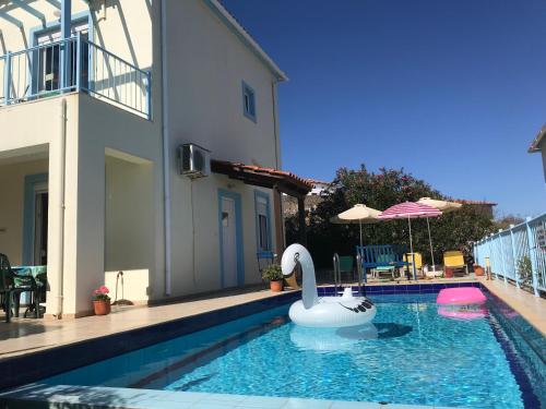 a swimming pool with a swan in a house at Breathtaking sea and Mountain views with Private pool, Peace full relaxing Villa with WiFi near Shops and Restaurants in Epáno Kefalás