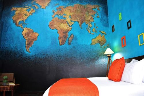 a bedroom with a map of the world on the wall at Tlaquepaque Pueblito in Guadalajara