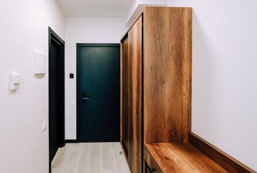 a hallway with a green door and a wooden partition at Hotel Doesi in Tbilisi City