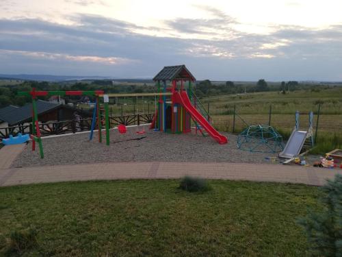 a playground with a red slide at Complex Turistic Dávid in Boghiş