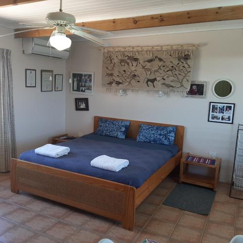 a bedroom with a bed with two pillows on it at Neels Cottage in Clanwilliam