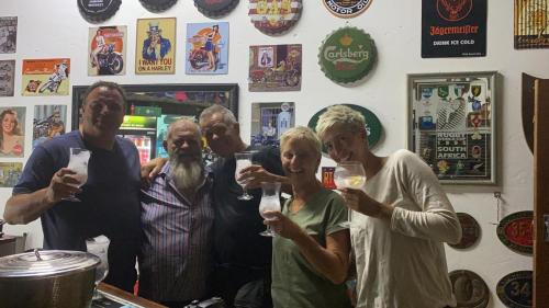 a group of people drinking wine in a bar at Palm Afrique Lodge in Ghanzi