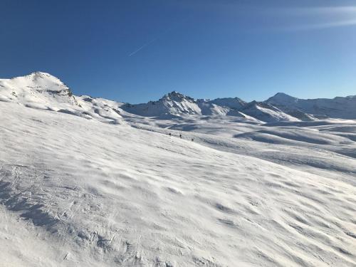 a group of people walking down a snow covered mountain at Val Claret, Tignes T2 tout confort de 36m2 in Tignes