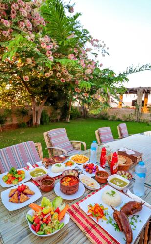 a table with plates of food on it at Tache Boutique Hotel Fayoum in Fayoum Center