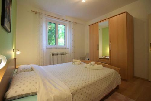 a bedroom with a bed with two towels on it at Apartments in Porec/Istrien 9899 in Poreč