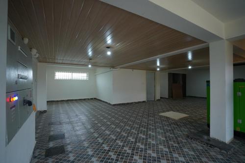 an empty room with a tile floor and a ceiling at DC comforts in Chikmagalūr