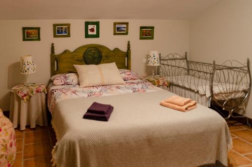 a bedroom with a large bed with towels on it at Casa Rural Cervarte in Argamasilla de Alba
