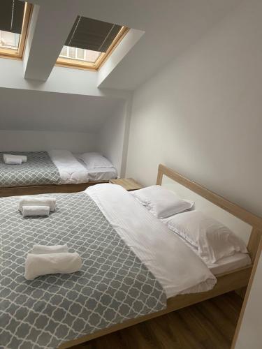 a bedroom with two beds with towels on them at Pristina Select Apartments in Prishtinë