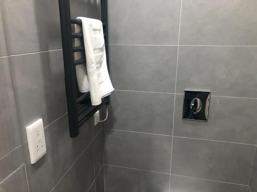 a bathroom with a white towel hanging on a wall at South Kensington Apartment x4, London in London