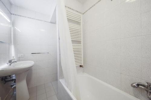 a white bathroom with a sink and a bath tub at Wonderful studio Wi-Fi AC in Venice