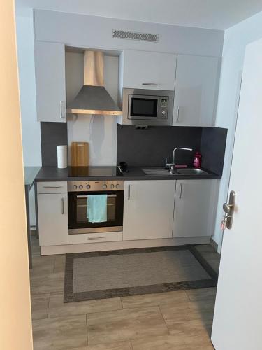 a kitchen with a stove and a microwave at Ferienwohnung Konstanz in Konstanz