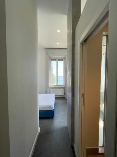 a bedroom with a bed and a window at Villino Saraceno Rostain in Borgio Verezzi