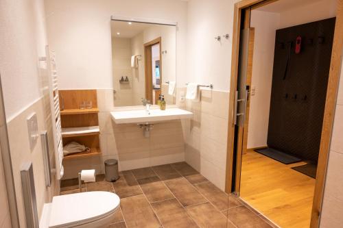 a bathroom with a sink and a toilet at Geisler-Moroder in Elbigenalp