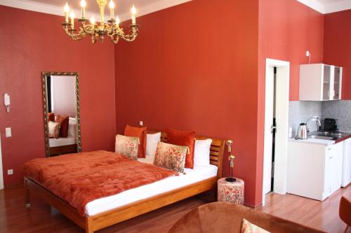 a bedroom with a bed with red walls and a mirror at Hotel Domstern in Cologne
