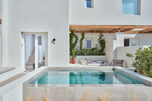 a swimming pool in the middle of a house at Lilium Homes in Karterados