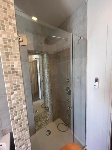 a shower with a glass door in a bathroom at Villino Saraceno Rostain in Borgio Verezzi