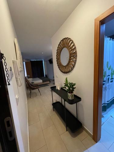 a hallway with a table and a mirror on the wall at Esmeralda Holidays Apartments in Funchal