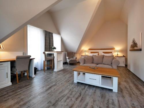 a living room with a couch and a table at Hotel Gräfrather Hof in Solingen