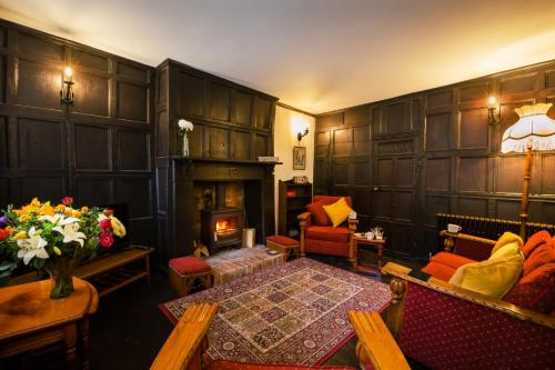 a living room with a fireplace and a couch and a table at "Wesley House" Historic home in town Centre with Parking in Shrewsbury