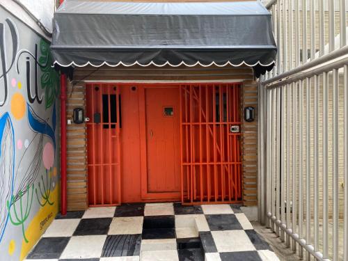 an entrance to a building with a red door at Ipanema Club Hostel in Rio de Janeiro