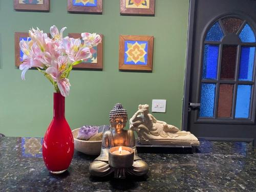a vase with a statue and a candle on a table at Ipanema Club Hostel in Rio de Janeiro