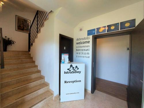 a stairway with a sign that reads physiotherapy reception at Rooms and Apartments IstraSoley in Bale