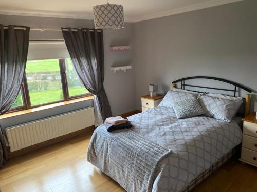 a bedroom with a bed and a large window at Gallagh Guest House self catering h18r252 Eircode in Monaghan