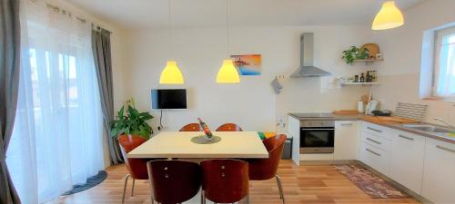 a kitchen with a table and chairs in a kitchen at Rooms and Apartments IstraSoley in Bale
