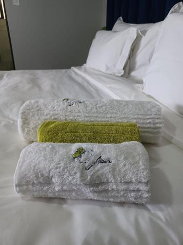 three towels sitting on top of a bed at Uzuri Lifestyle in Port St Johns